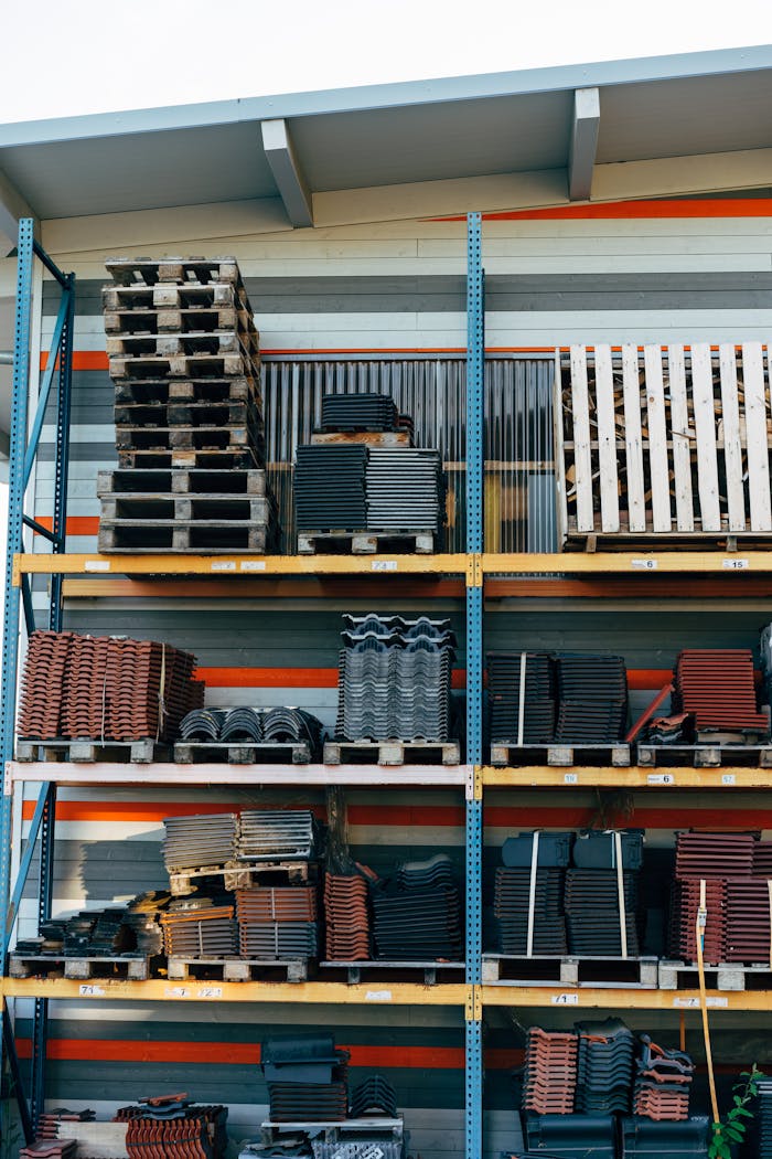 Neatly stacked building materials in a warehouse setting, showcasing construction organization.